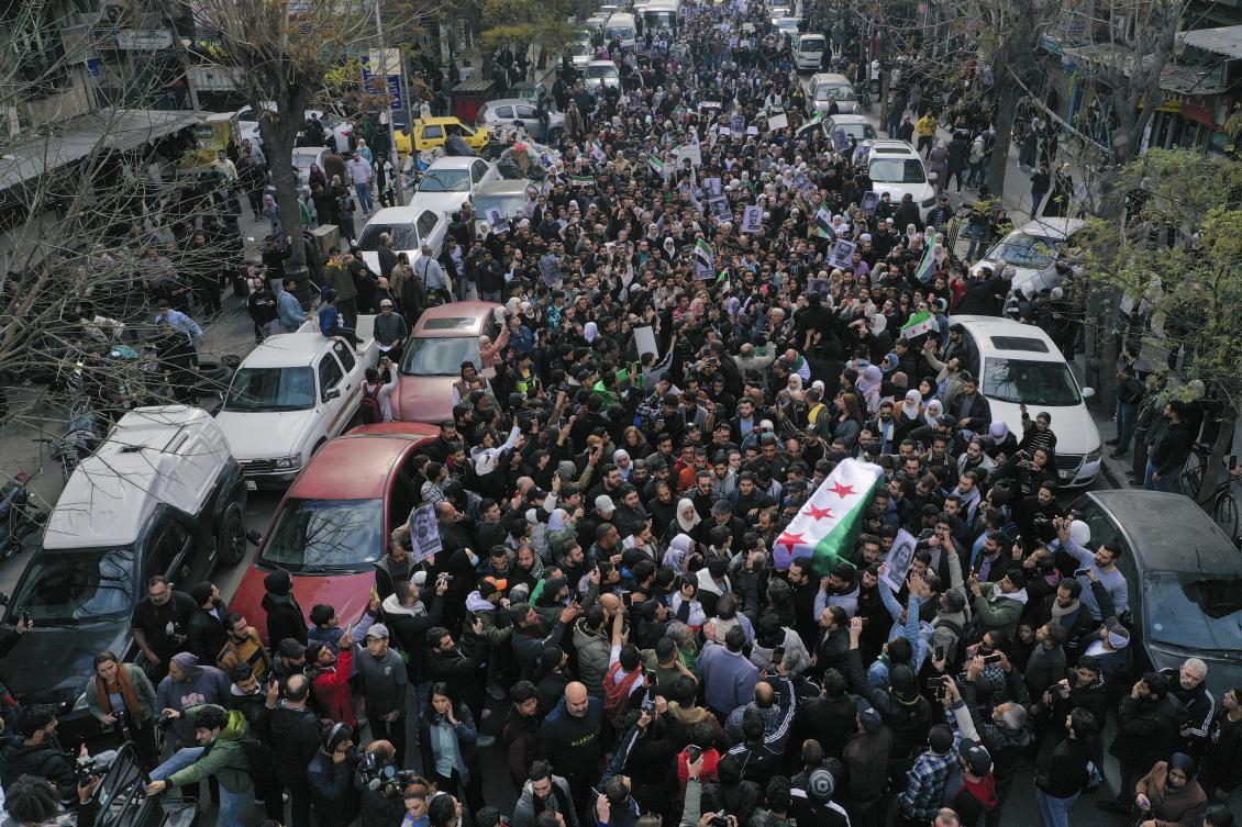 The coffin of Syrian activist Mazen Al-Hamada is carried for burial in Damascus, Dec. 12, 2024. (AP)