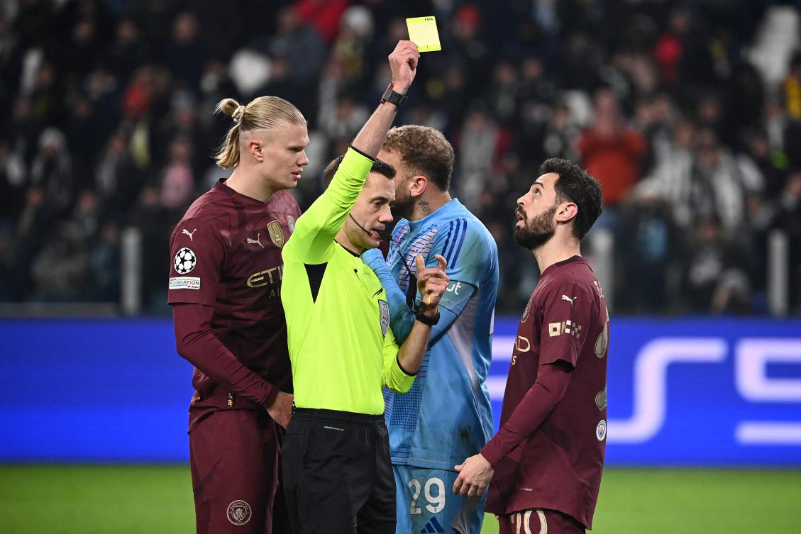 French referee Clement Turpin shows a yellow card to Manchester City’s Portuguese midfielder Bernardo Silva for a foul on Juventus’ Italian defender Federico Gatti during their UEFA Champions League match at the Allianz stadium in Turin, on Dec. 11, 2024. (AFP)