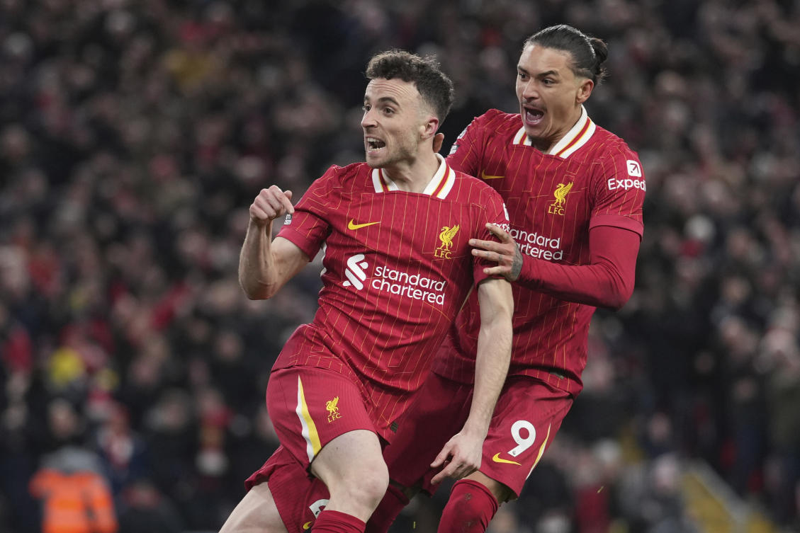 Liverpool’s Diogo Jota celebrates with Darwin Nunez after scoring his side’s second goal during their English Premier League match against Fulham, at Anfield stadium in Liverpool, on Dec. 14, 2024. (AP)
