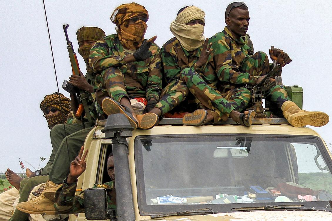 Fighters ride in a vehicle moving in a military convoy accompanying the governor of Sudan's Darfur State during a stopover in the eastern city of Gedaref while on the way to Port Sudan on August 30, 2023. (Photo by AFP)