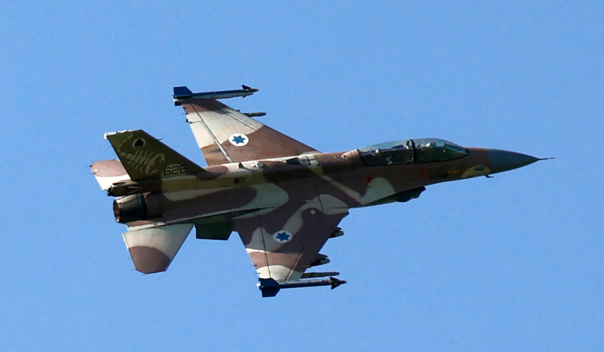 This picture taken from northern Israel shows an Israeli Air Force fighter jet flying over the border area with south Lebanon on March 12, 2024, amid ongoing cross-border tensions as fighting continues between Israel and Hamas militants in Gaza. (AFP)