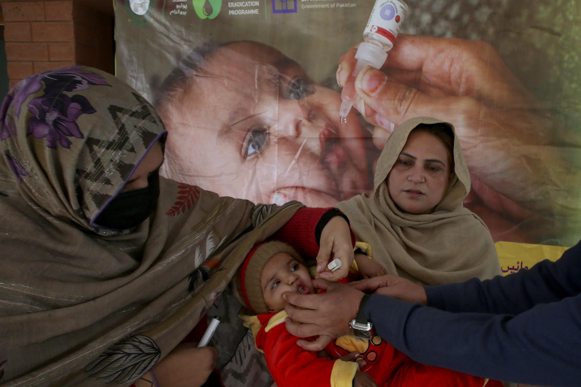 Above, a health worker administers a polio vaccine to a child at a health center in Peshawar, Pakistan on Dec. 16, 2024. (AP)