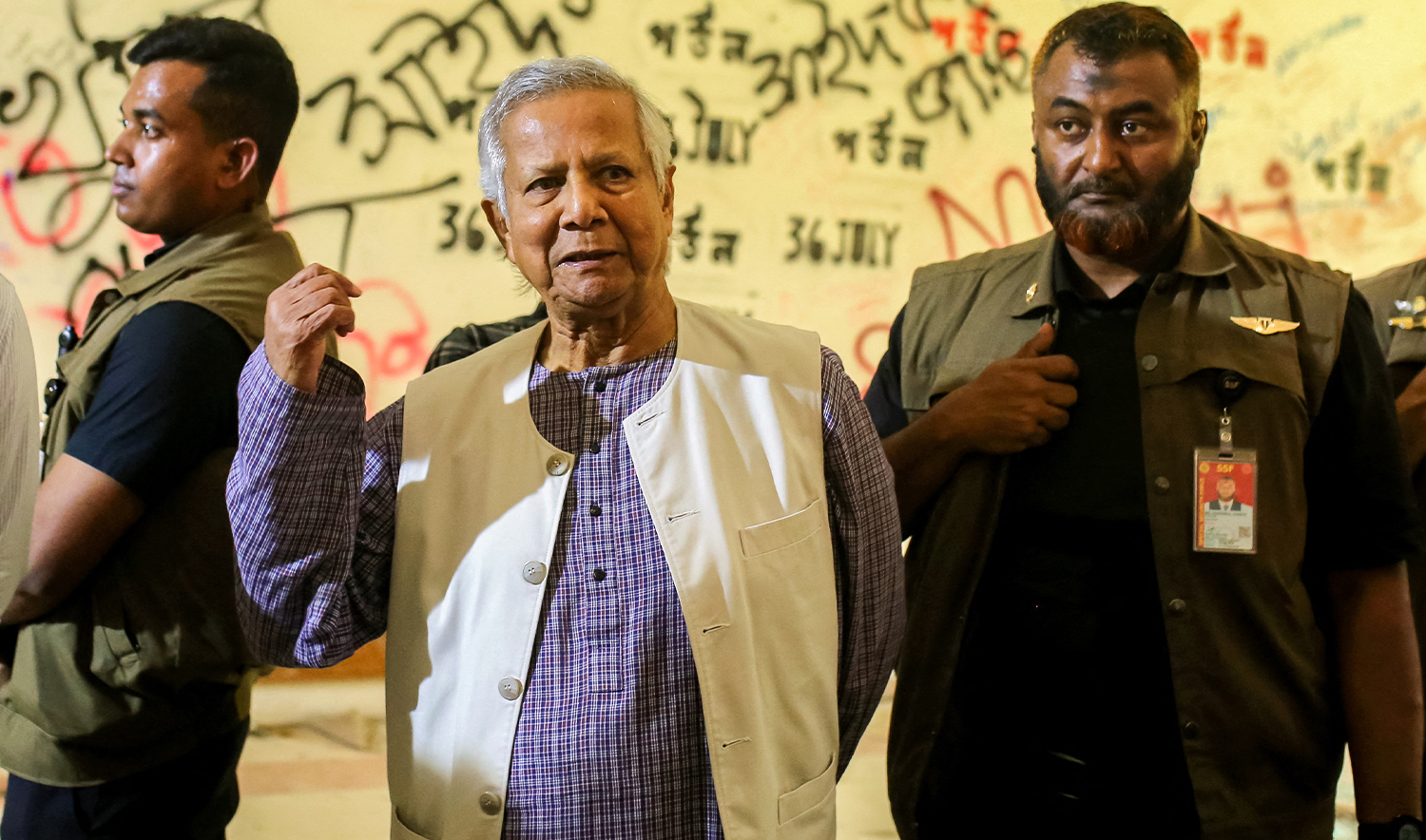 This handout photograph taken on October 28, 2024 and released by the Press Wing of Bangladesh's Chief Adviser shows Nobel laureate and chief adviser of Bangladesh's interim government Muhammad Yunus (C) as he tours the battered Gonobhaban palace, the former official residence of the ousted prime minister Sheikh Hasina in Dhaka. (AFP /Press Wing of Bangladesh's Chief Advisor)