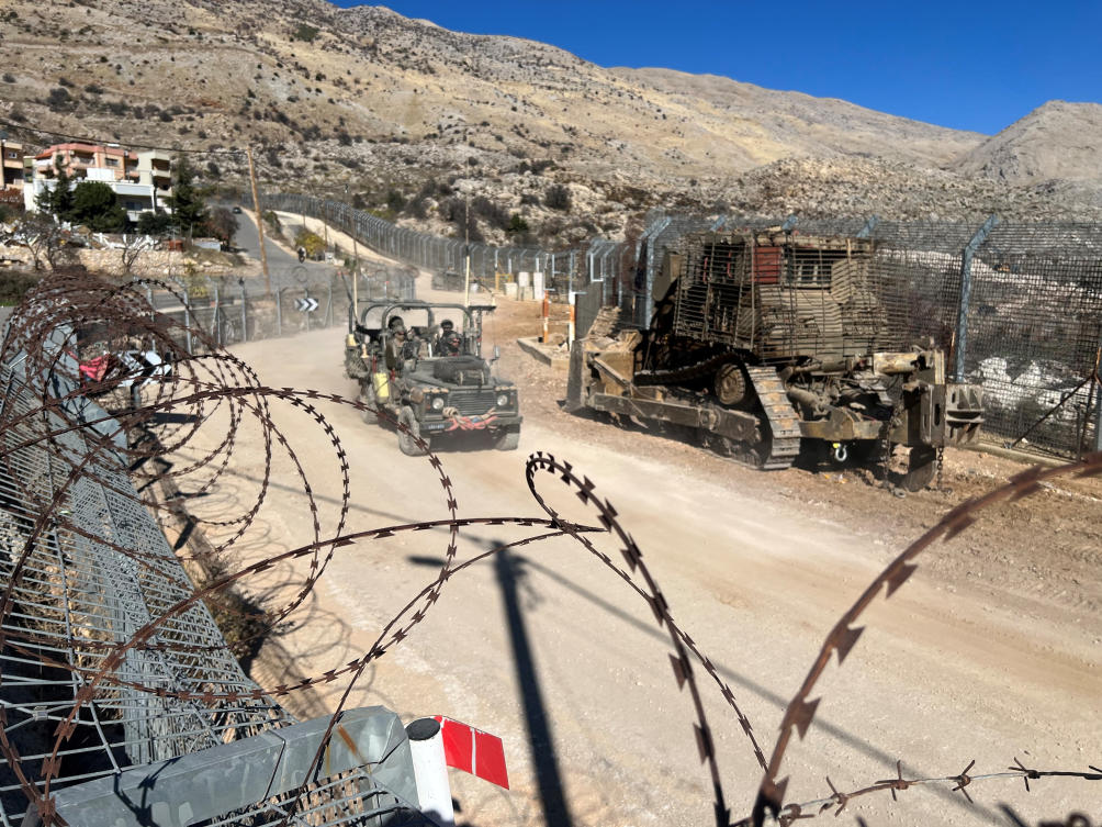 Israeli soldiers ride in a military vehicle along the ceasefire line with Syria and the Israeli-occupied Golan Heights, as seen from the Golan Heights, December 15, 2024. (Reuters)