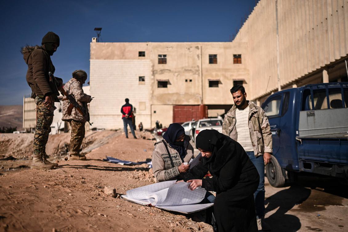 A woman looks at records of prisoners at the Saydnaya prison, north of the Syrian capital Damascus, as she searches for her missing husband on December 15, 2024. (File/AFP)