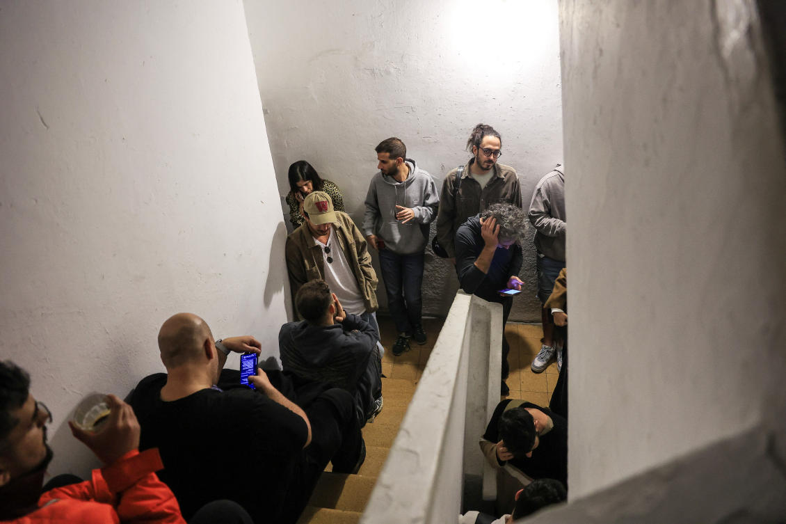 People take cover in the stairway of a building, while sirens sound in Tel Aviv, Israel, December 16, 2024. (Reuters)