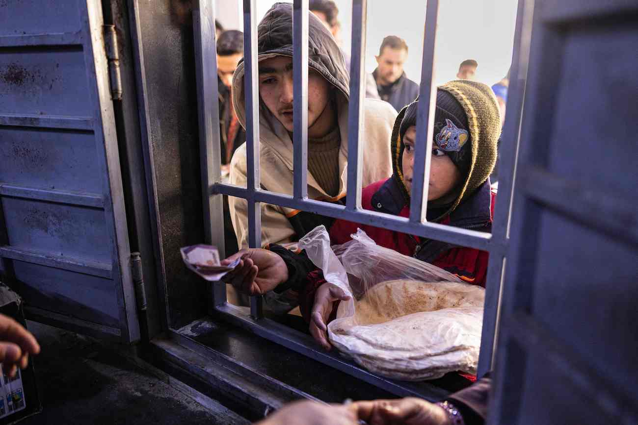 Syrians buy bread in the town of Douma on the outskirts of the capital Damascus on December 15, 2024. (AFP)