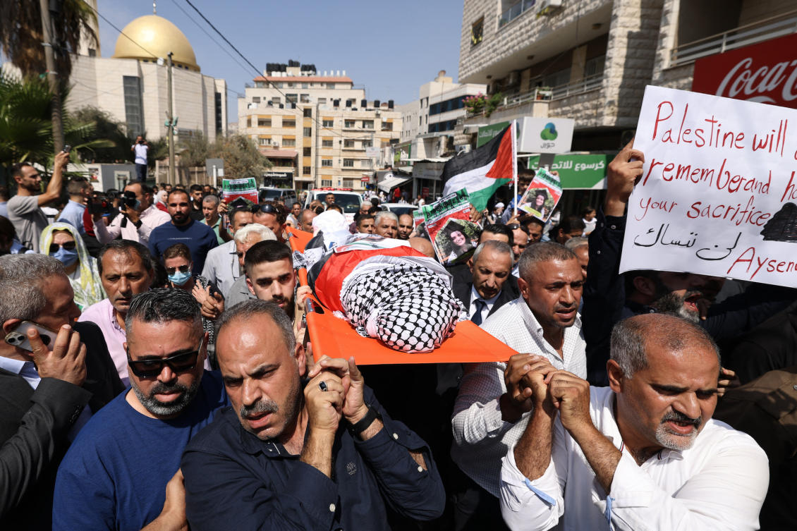 Palestinians carry the body of slain Turkish-American activist Aysenur Ezgi Eygi, covered with a keffiyeh and the Palestinian flag, during a memorial service in the occupied West Bank. (File/AFP)
