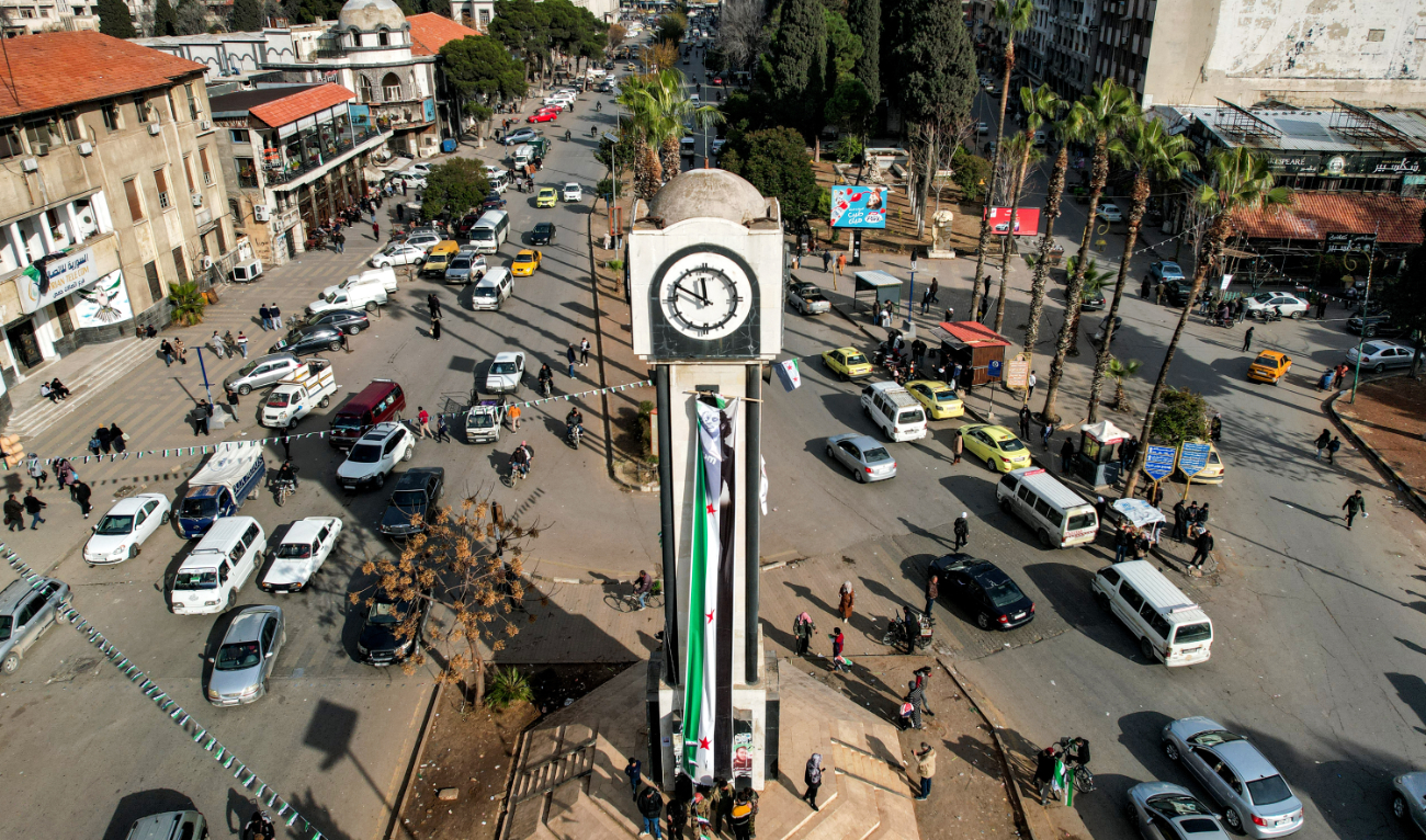 This aerial view shows traffic around the New Clock Tower along Quwatli Street in the Shayah district of Homs on December 16, 2024. (AFP/File)