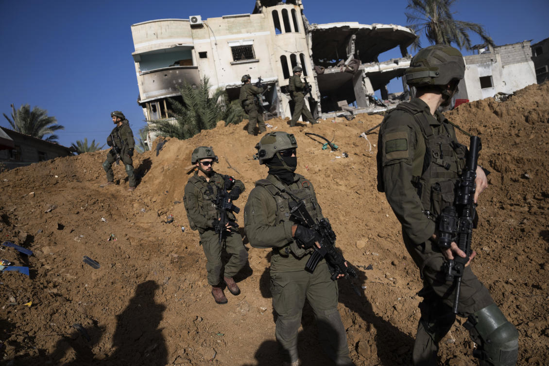 Israeli army troops walk near a destroyed building during a ground operation in Khan Younis, Gaza Strip. (File/AP)