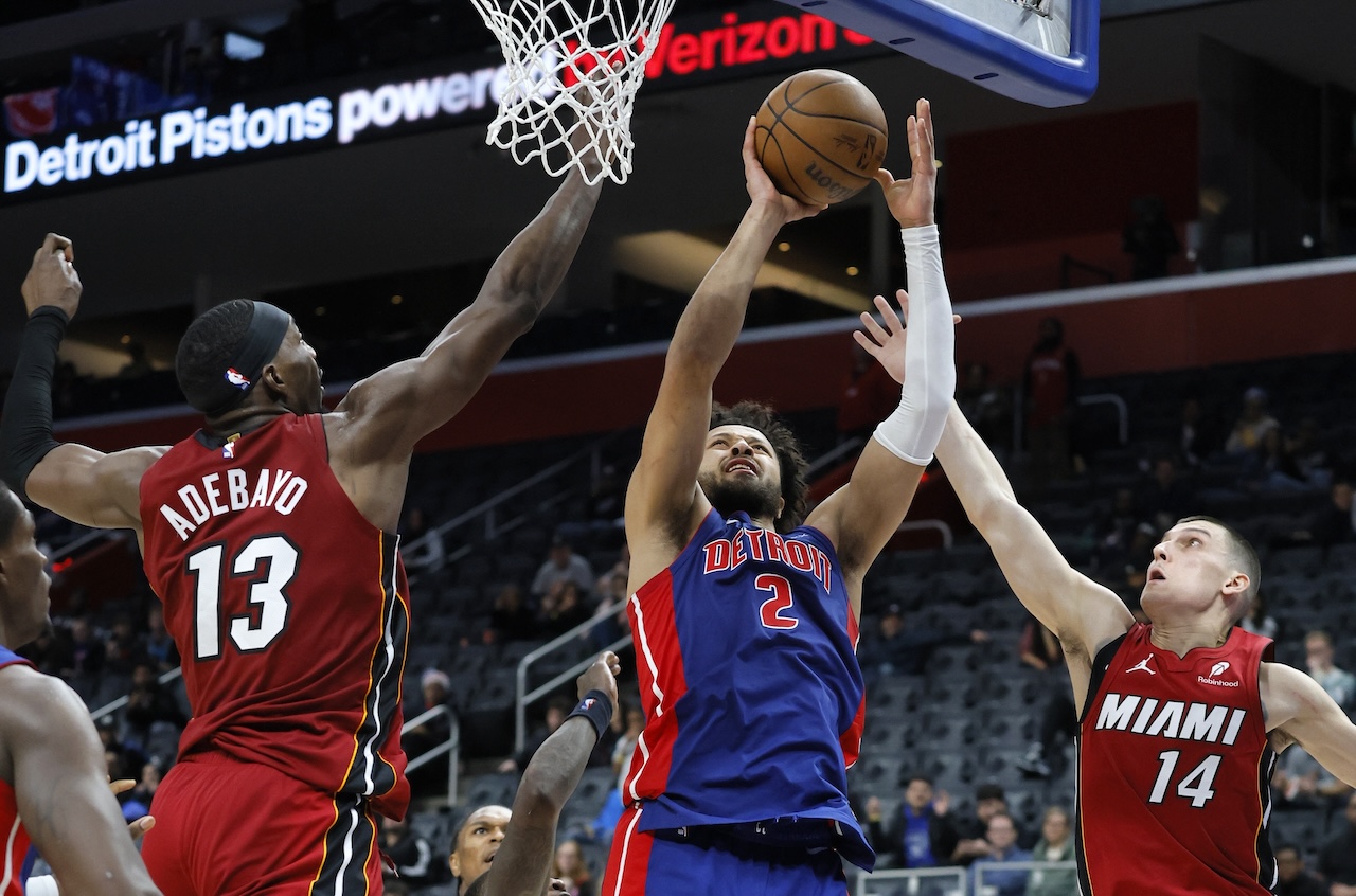 Detroit Pistons guard Cade Cunningham (2) goes up to shoot against Miami Heat center Bam Adebayo (13) and guard Wendell Moore Jr. during the overtime of an NBA basketball game Monday in Detroit. (AP)