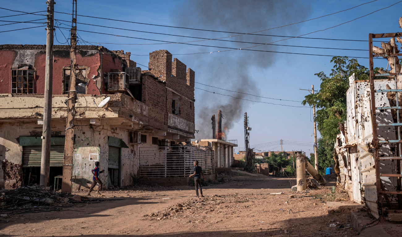 Boys check a fire that broke out in a destroyed house in a war-torn neighborhood in Omdurman on November 2, 2024. (AFP/File)