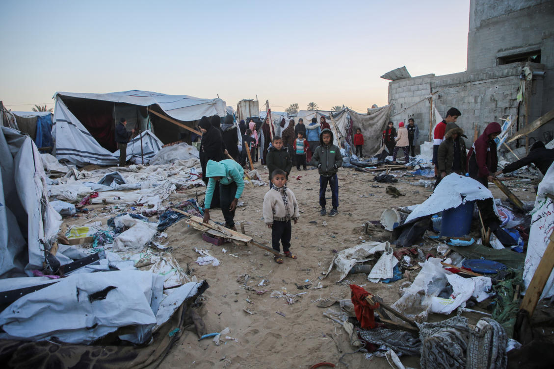 A Palestinian boy looks as others inspect the damage at a tent camp sheltering displaced people, following an Israeli strike, amid the Israel-Hamas conflict, in Al-Mawasi area, in Khan Younis, southern Gaza Strip, December 18, 2024. (Reuters)