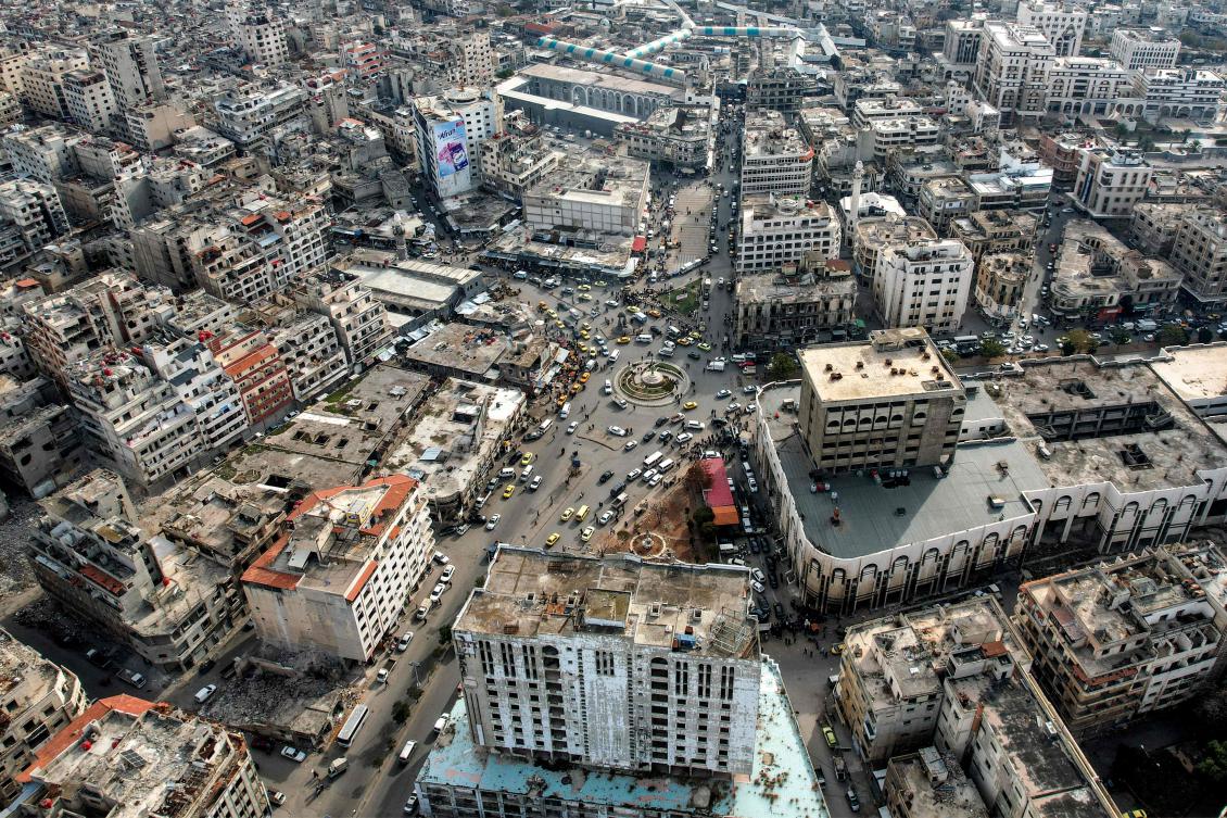 This aerial view shows traffic around the Old Clock Tower along Quwatli Street in the Hamidiyah district of Homs on December 16, 2024. (AFP)