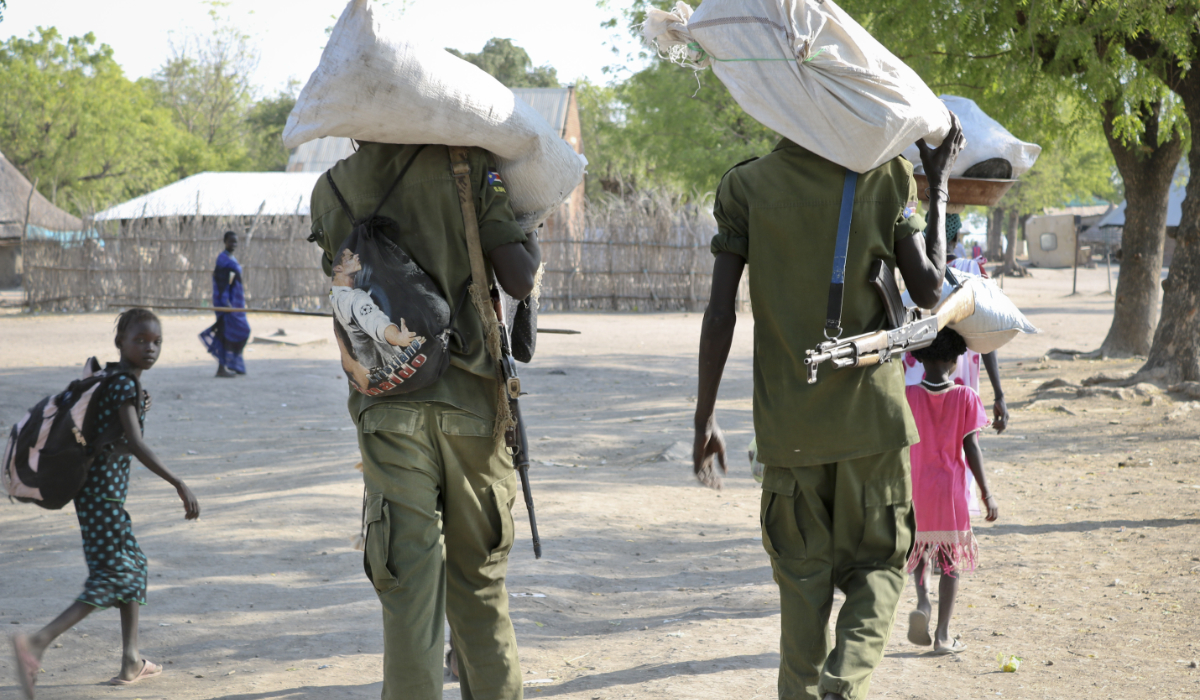 In this photo taken Friday, Jan. 19, 2018, rebel fighters walk through town after receiving food in Akobo, near the Ethiopian border, in South Sudan. (AP)