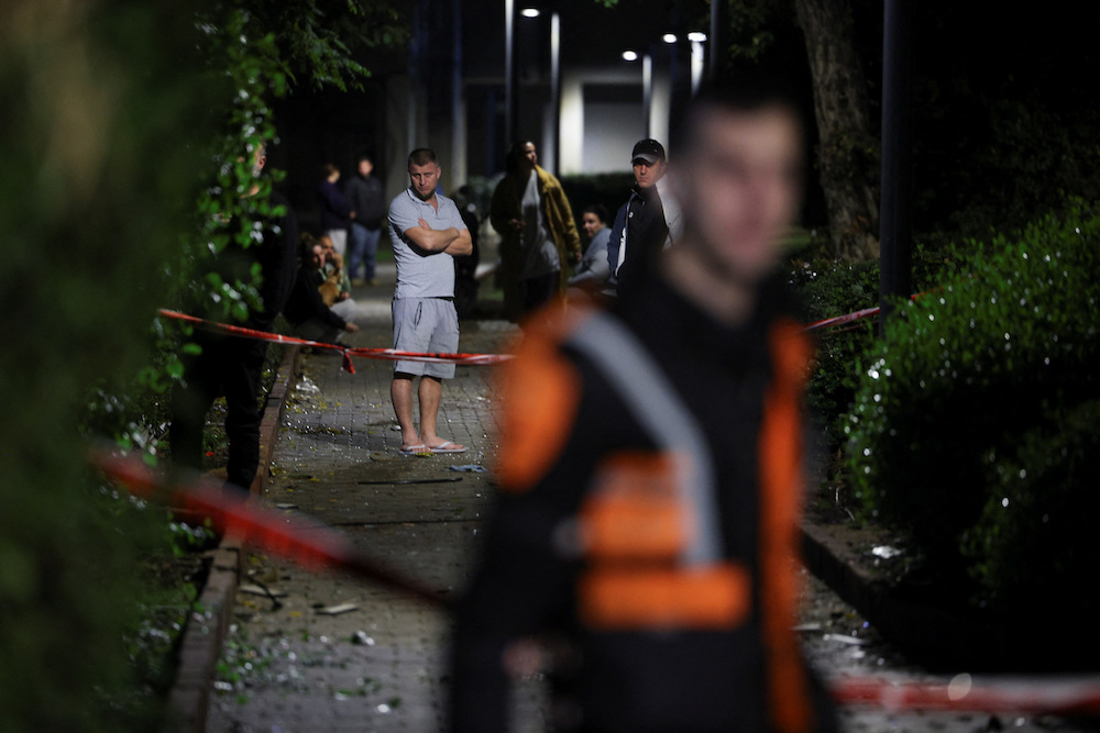 Residents gather at the scene of a missile strike that, according to Israel’s military, was launched from Yemen and landed in Jaffa, south of Tel Aviv on Dec. 21, 2024. (Reuters)