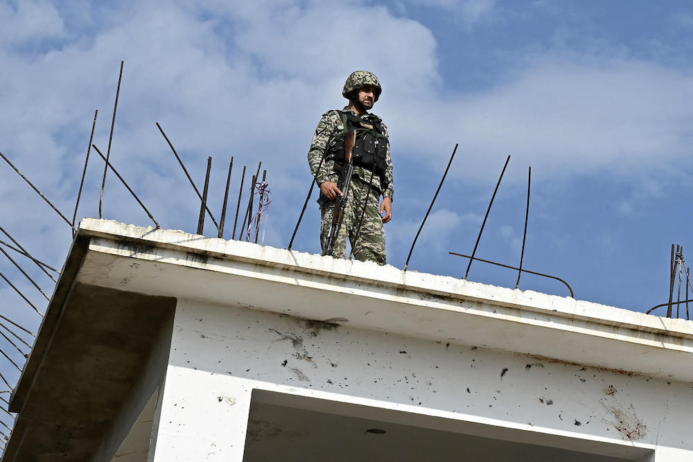 Pakistan militants launched a brazen overnight raid on an army post near the Afghan border. Above, a security personnel stands guard in Bajaur district of Khyber-Pakhtunkhwa province on July 31, 2023. (AFP file photo)