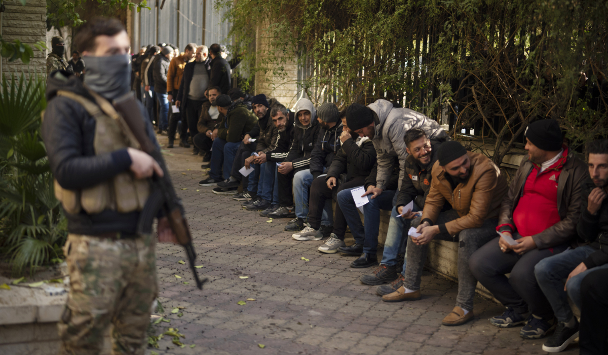 Members of Bashar Assad's army, or a pro-government militia, line up to register with Syrian rebels as part of an "identification and reconciliation process" in Damascus, Syria, Saturday, Dec. 21, 2024. (AP)