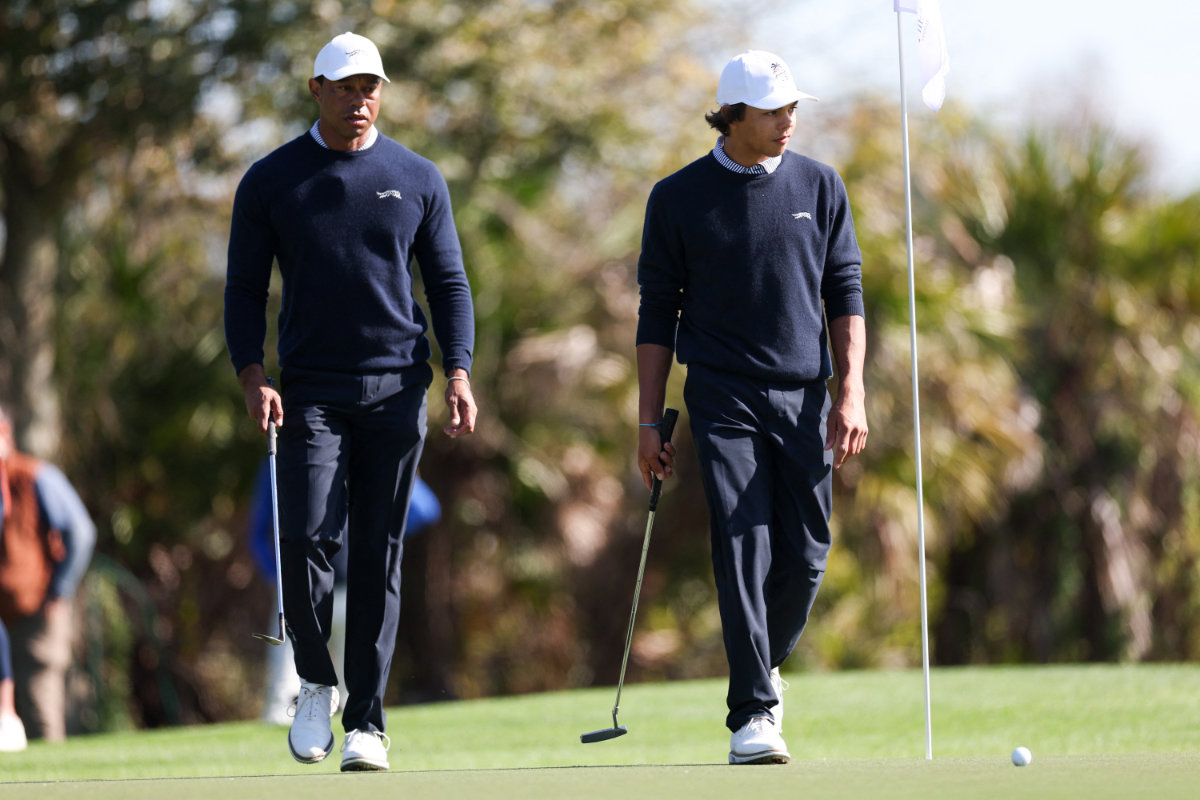 Tiger Woods and son Charlie Woods walk to the third green during the PNC Championship at The Ritz-Carlton Golf Club in Orlando, Florida, Dec 21, 2024. (Reuters)