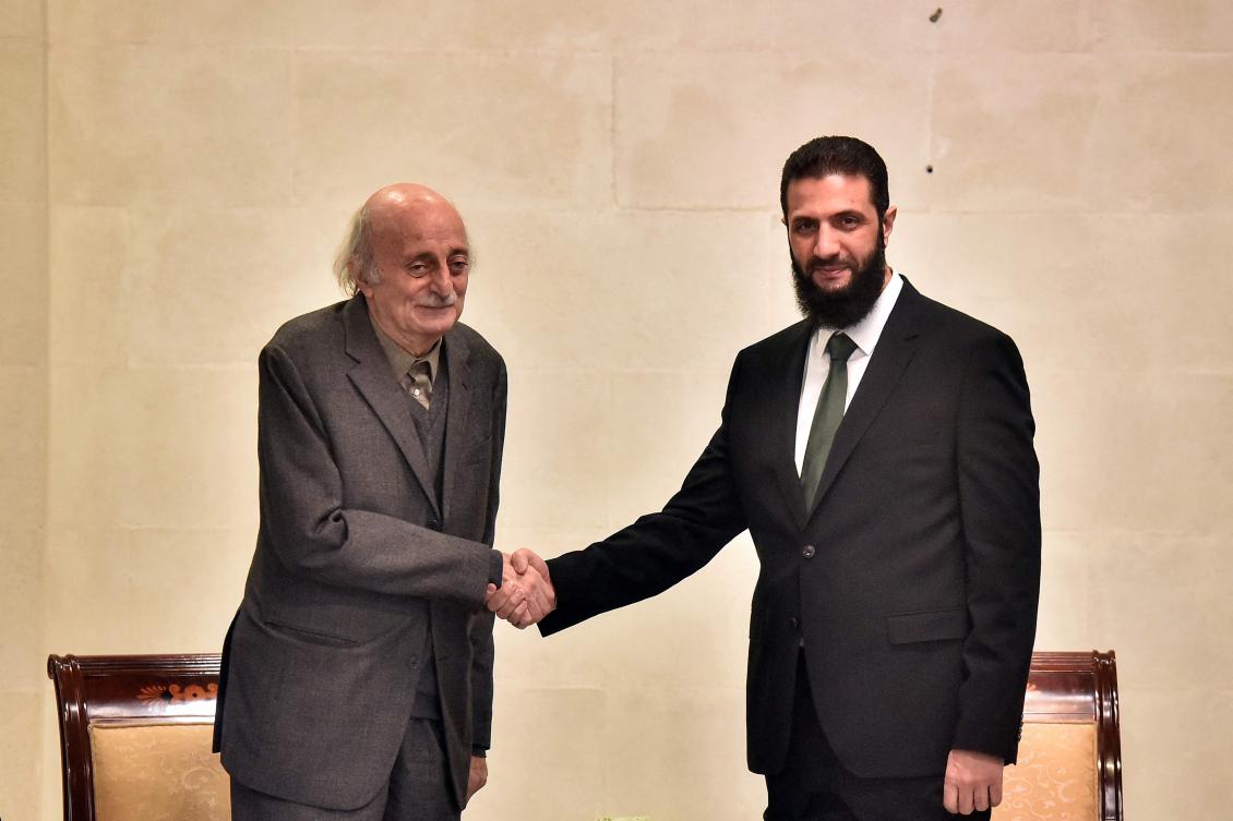 Lebanese Druze leader Walid Jumblatt, left, shakes hands with Syrian leader Ahmed Al-Sharaa during a visit to Damascus on Dec. 22, 2024. (AFP)