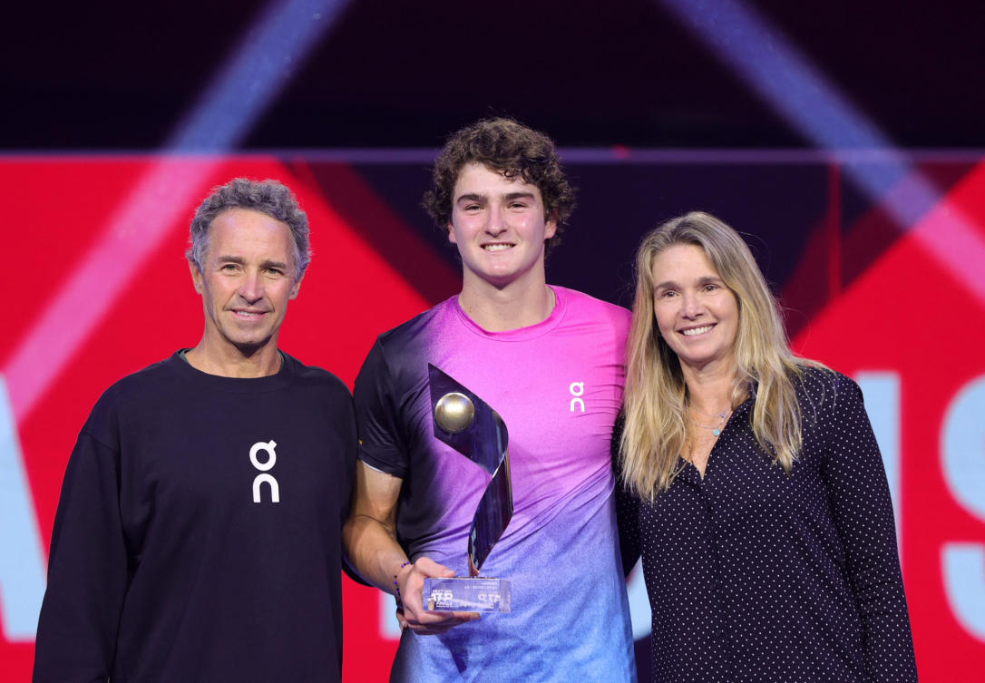Brazil’s Joao Fonseca poses with his parents Roberta and Christiano Fonseca and the trophy after winning the Next Gen final match against Learner Tien of the US. (Reuters)