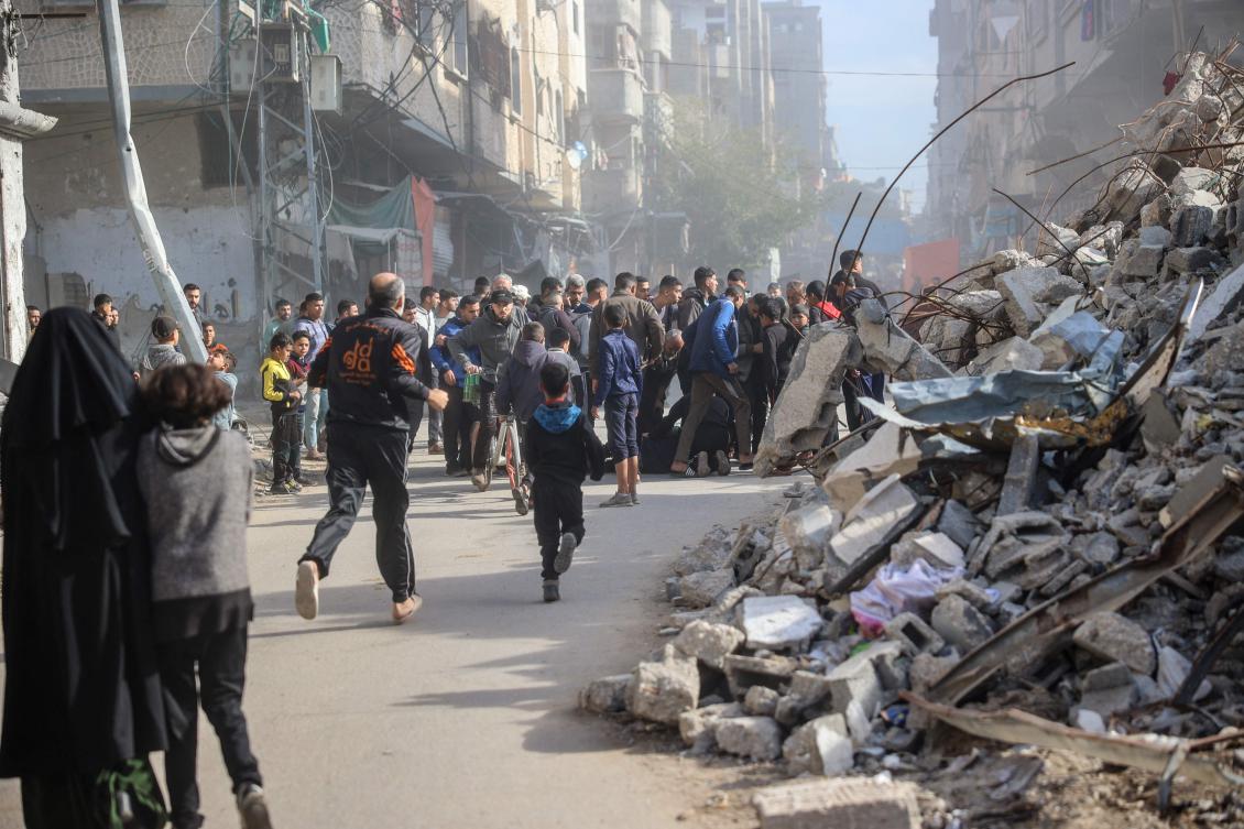 People rush to the aid of a man injured in an Israeli strike on the Bureij refugee camp in the central Gaza Strip on December 22, 2024, amid the ongoing war between Israel and the Palestinian militant group Hamas.(AFP)