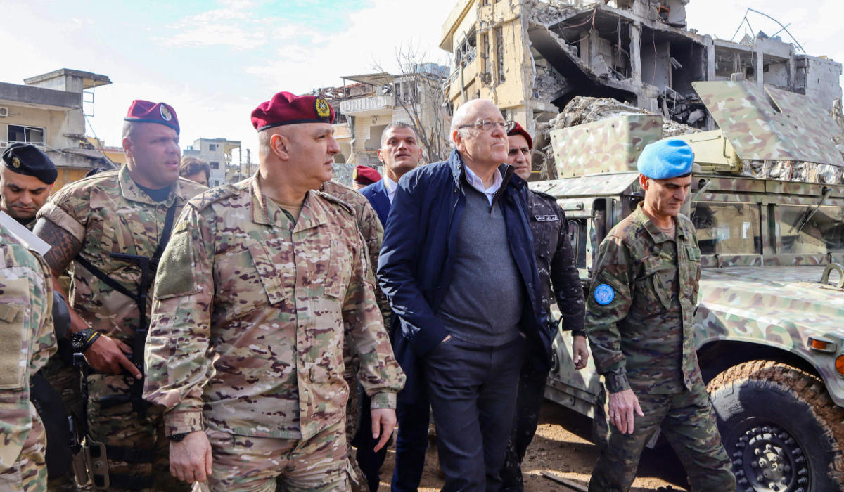 Lebanon's caretaker Prime Minister Najib Mikati, Lebanese army commander, General Joseph Aoun, and Major General Aroldo Lazaro, Head of Mission and Force Commander of the United Nations Interim Force in Lebanon (UNIFIL) (R) visit the southern Lebanese village of Khiam on December 23, 2024, after the withdrawal of Israeli forces from the area under a ceasefire deal with Hezbollah. (AFP)