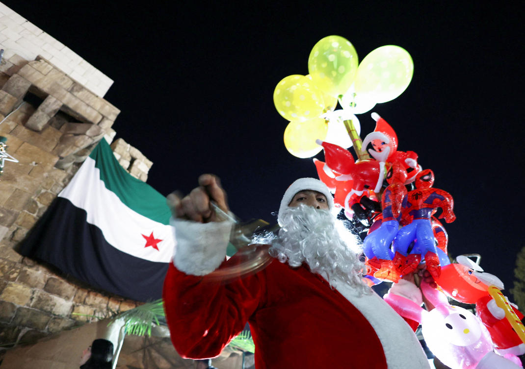 A Syrian street vendor dressed as Santa Claus in Damascus, after Syria's Bashar al-Assad was ousted, December 22, 2024. (Reuters)