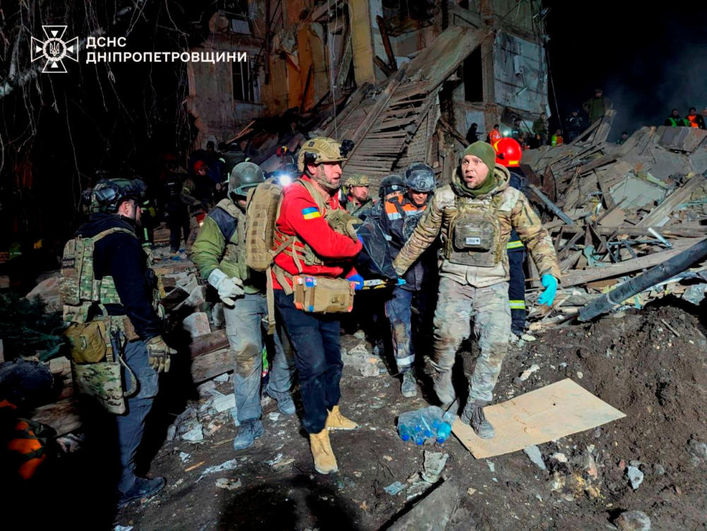 Rescuers carry the body of a killed person at the site where an apartment building was hit by a Russian missile strike in Kryvyi Rih, Ukraine December 24, 2024. (Reuters)