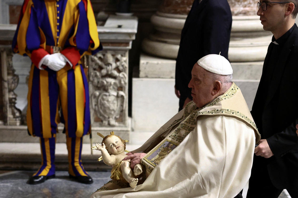 Pope Francis holds a figurine of baby Jesus during the Christmas Eve Mass in St. Peter’s Basilica at the Vatican, December 24, 2024. (Reuters)