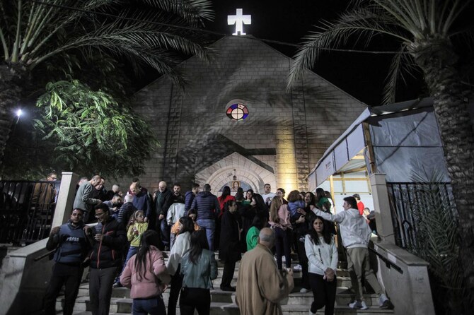 Worshippers walk outside after Christmas Eve mass at the Roman Catholic Church of the Holy Family Church in the Zaytoun neighbourhood of Gaza City on December 24, 2024. (AFP)