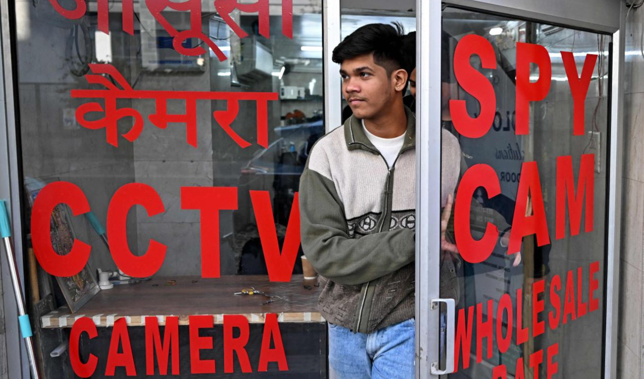 In this photograph taken on December 10, 2024, a man walks out of a shop selling spy cameras at a market in New Delhi. Elaborate Indian weddings are big business, and for some families the first step of celebration is not to call a priest or a party planner — but a private detective. (AFP)
