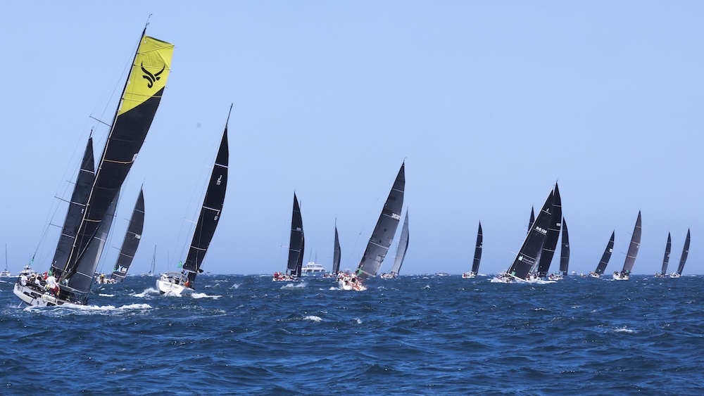 Competitors sail out of the heads following the start of the Sydney to Hobart yacht race in Sydney Thursday. (AAP Image via AP)