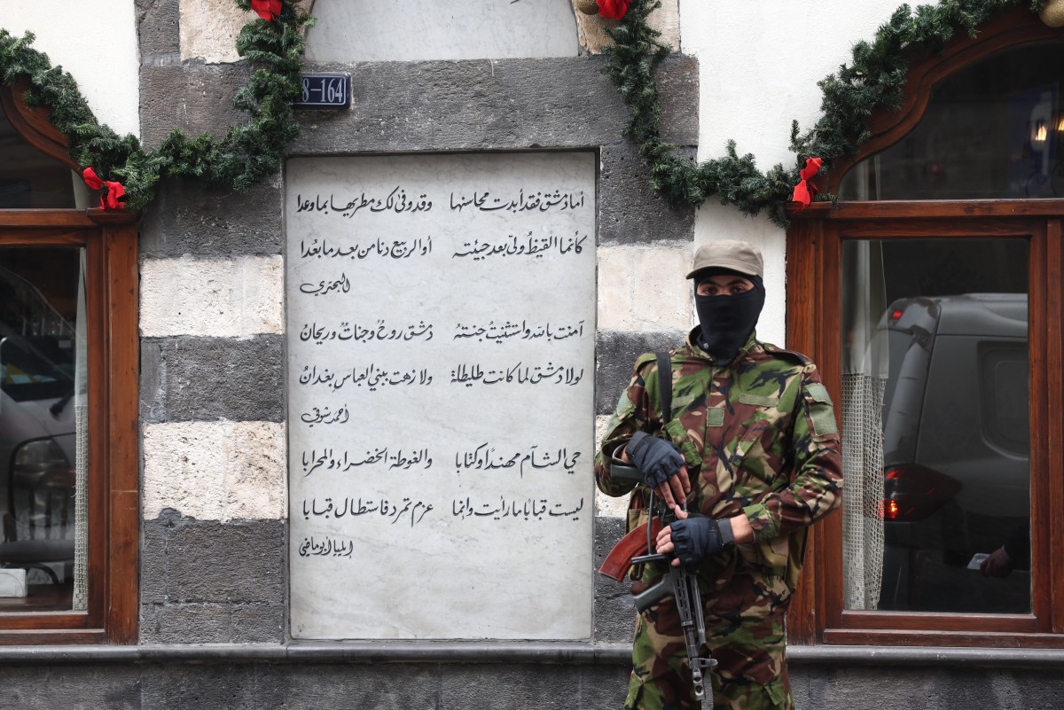 A member of the Syrian security forces, affiliated with the transitional government, stands guard in a street in the capital Damascus on December 24, 2024. (AFP)