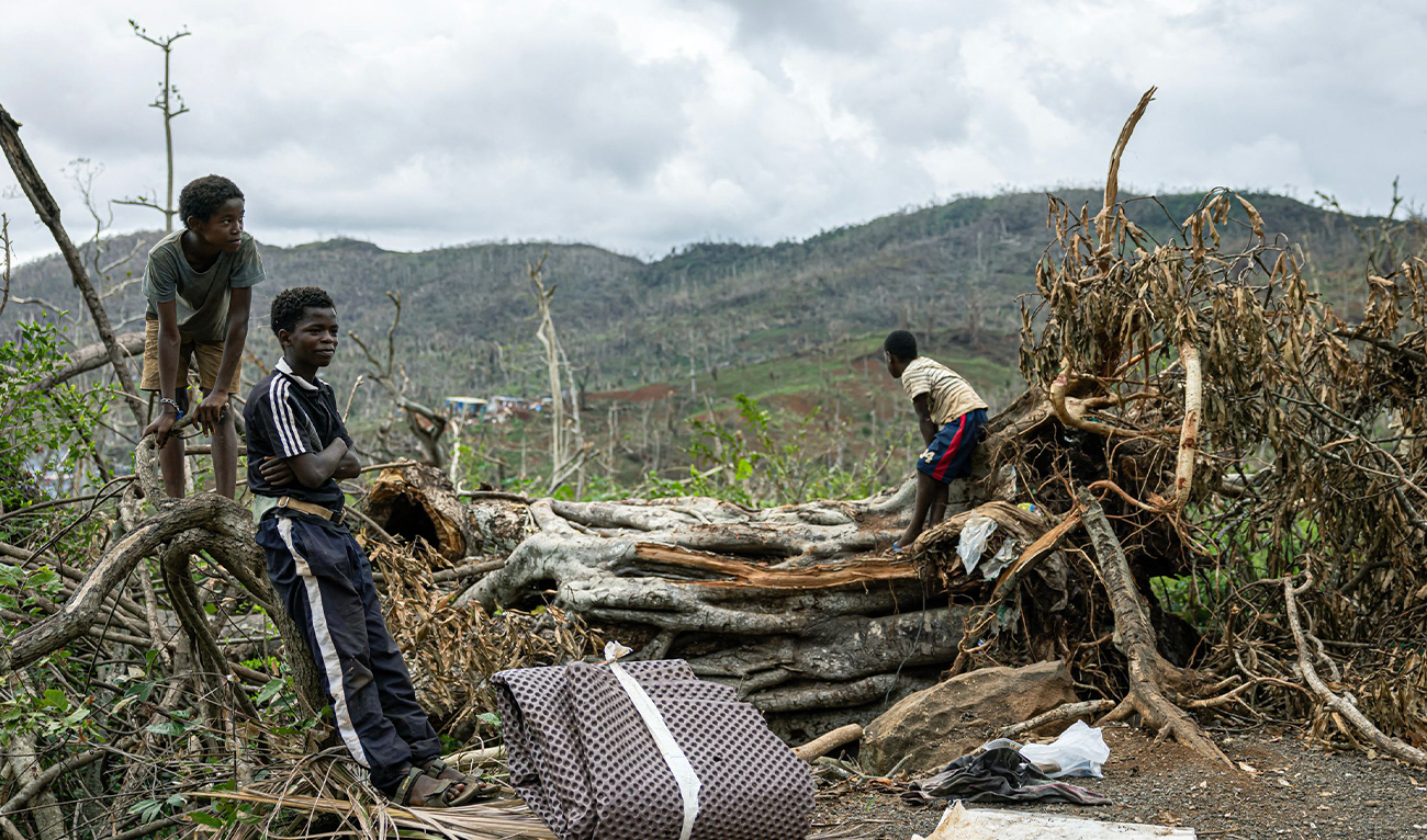 Children stand on the roadside on the outskirts of the town of Ongojou, on the French Indian Ocean territory of Mayotte on December 26, 2024. (AFP)