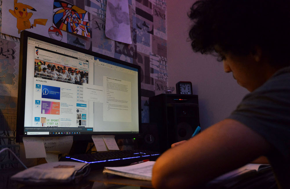 Above, a student attends online classes at the French International Lycee in Riyadh. (AFP file photo)