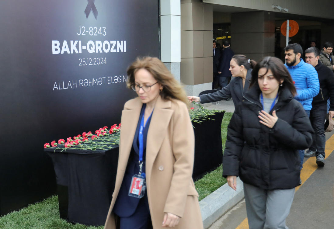People commemorate victims of an Azerbaijan Airlines’ passenger plane crash at a memorial installed outside an airport in Baku, Azerbaijan on Dec. 26, 2024. (Reuters)