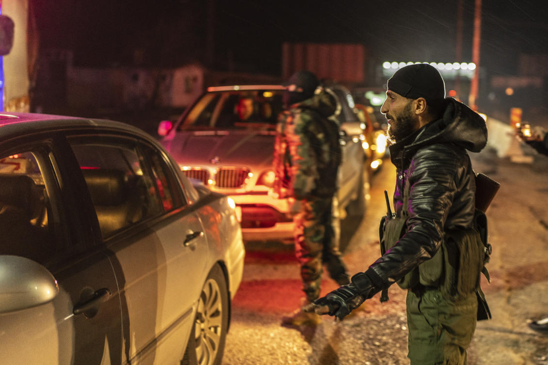 Members of the security forces of the newly formed Syrian government stand guard at a security checkpoint on the Syrian border with Lebanon on Friday. (AP)