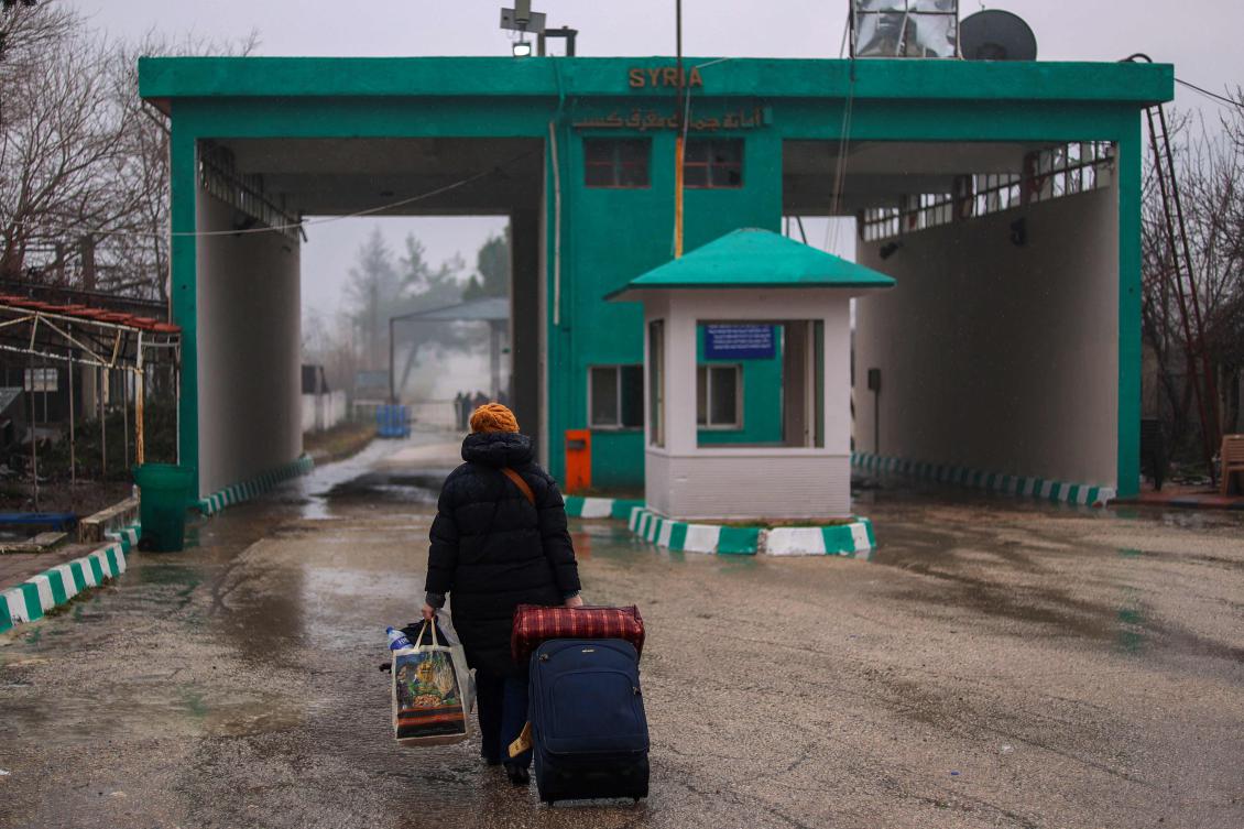 A woman crosses into Syria from Turkey through the Kassab crossing on Dec. 27. (AFP)