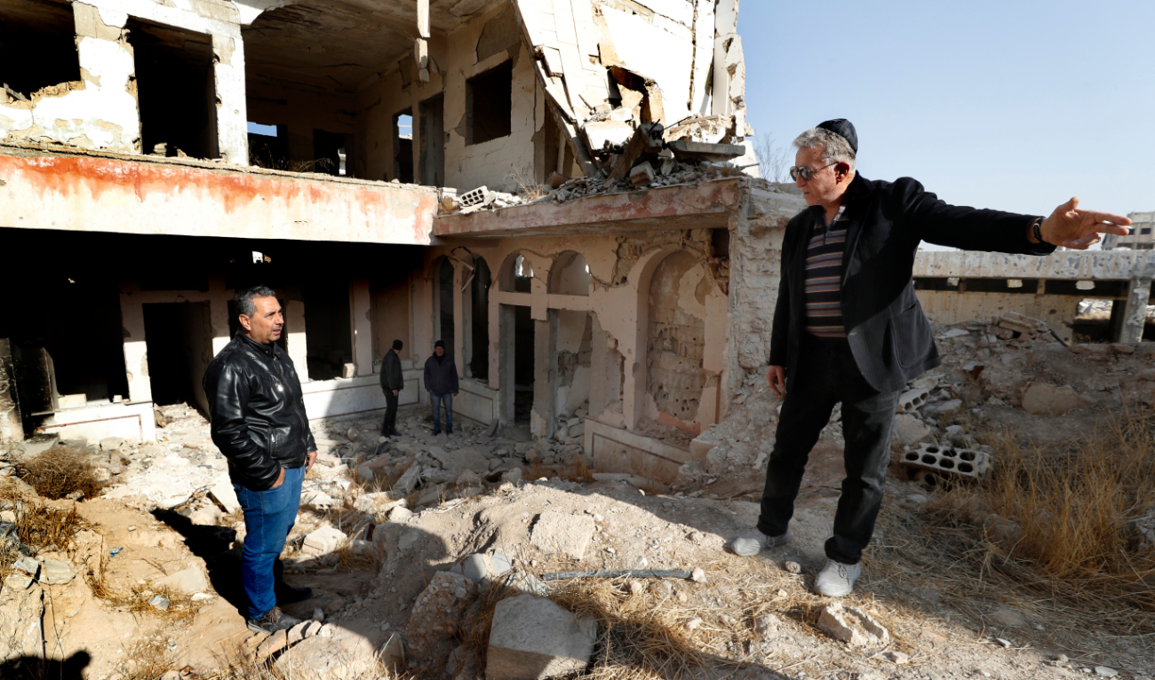 Bakhour Chamantoub, 74, right, head of the Jewish community in Syria, speaks with a local man during his visit to the destroyed Jobar Synagogue, also known as Eliyahu Hanavi, in Damascus. (AP)
