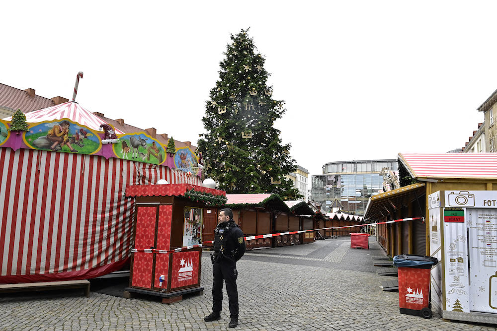 A police guards the closed Christmas market where a car crashed into a crowd injuring more than 200 people the evening before, on early Dec. 21, 2024 in Magdeburg, eastern Germany. (AFP)