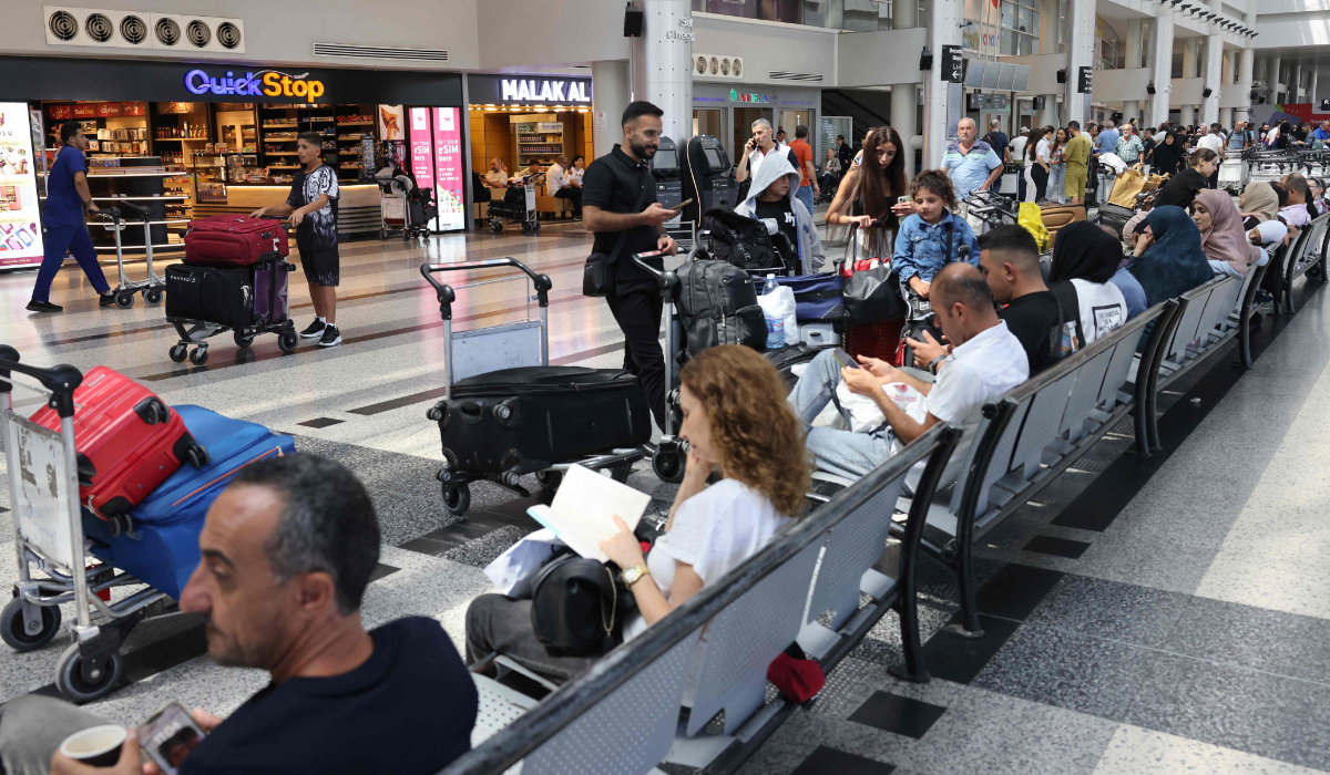 Passengers wait for their flights at the Beirut International Airport in Beirut on August 25, 2024. (AFP)