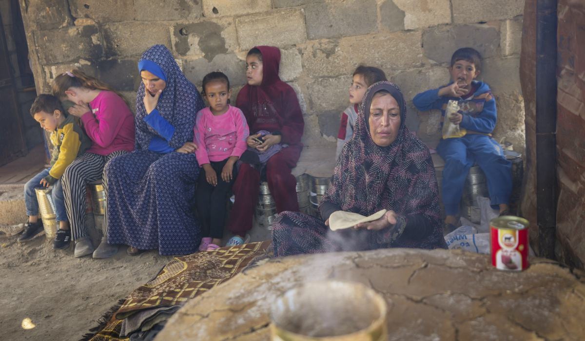 Amal Al-Jali, a 46-year-old mother of 14 displaced from Gaza City, prepares bread at a camp for displaced Palestinians in Deir al-Balah, Gaza Strip, on Nov. 7, 2024. (AP)