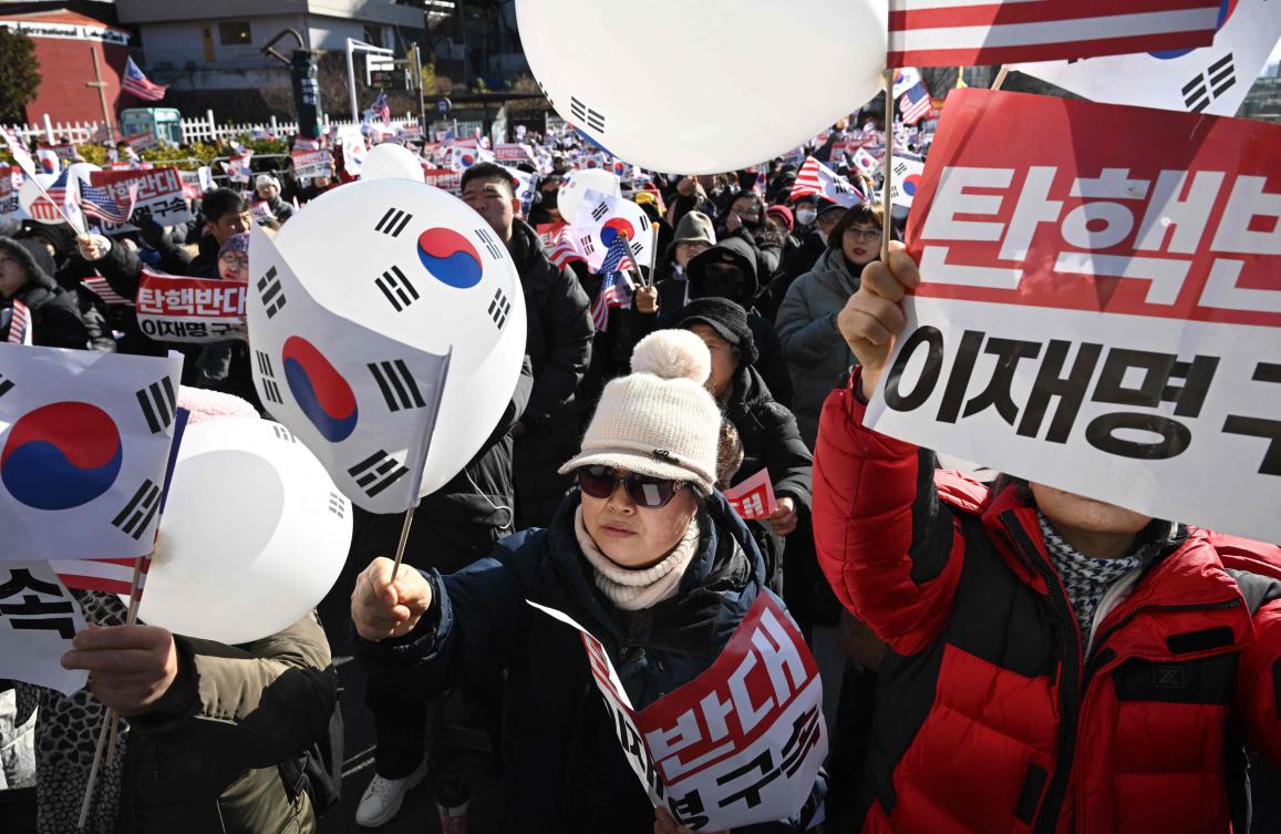 Above, supporters of impeached South Korea President Yoon Suk Yeol gather near the presidential residence in Seoul on Dec. 31, 2024. (AFP)