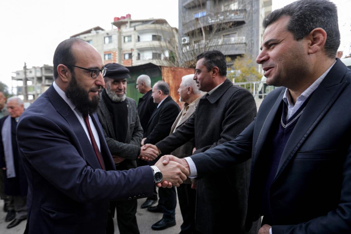 Shadi Mohammad Al-Waisi, Justice Minister for Syria’s interim government, (L) arrives for a meeting with local officials, judges, and lawyers in Syria’s southern city of Sweida on Dec. 29. (AFP)