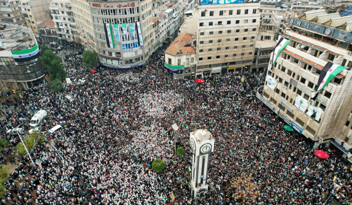 Syrians around the Clock Tower in Homs as they celebrate the fall of Bashar al-Assad's iron-fisted rule. (AFP)