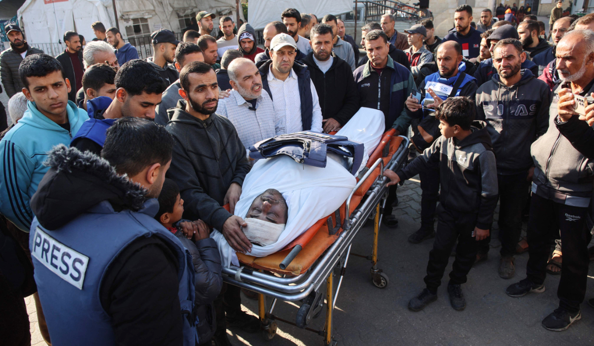 Mourners surround the body of Palestinian journalist Mamduh Qantiya who was killed in an Israeli strike in Gaza. (AFP)