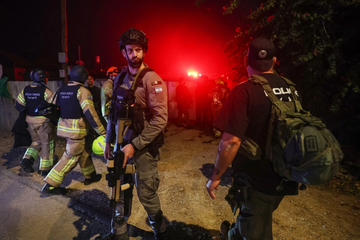 File photo of Israeli security forces stand at the scene after a projectile was fired from south Lebanon. (AFP)