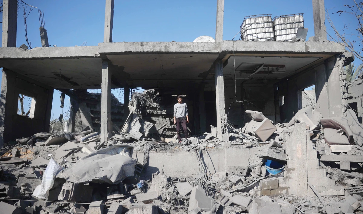 A Palestinian boy inspects the destruction at the site of an Israeli strike that targeted a house in the Bureij refugee camp in the central Gaza Strip on Monday. (AFP)