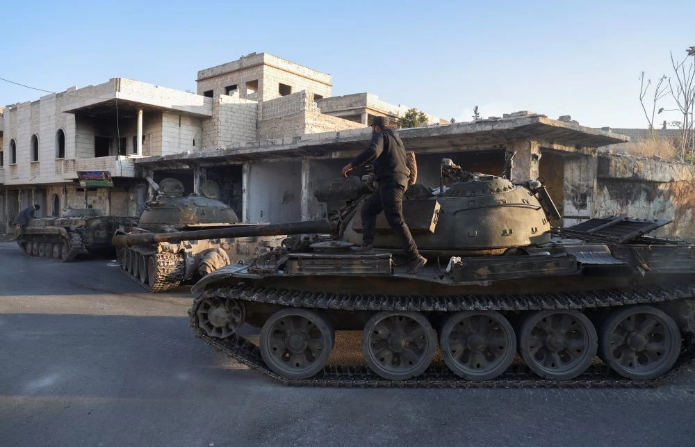 Syrian opposition fighters maneuver using armored vehicles seized from the Syrian army in the town of Maarat Al-Numan, south of Idlib, Syria, Tuesday, Dec. 3, 2024. (AP Photo)